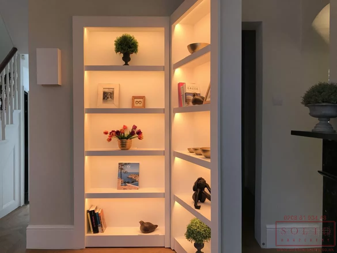 A secret bookcase door with lights and books